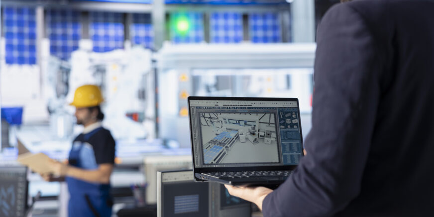 Photovoltaics factory specialist creates CAD models and technical drawings for solar modules using laptop. Man uses notebook to develop solar panel designs for efficiency and manufacturability